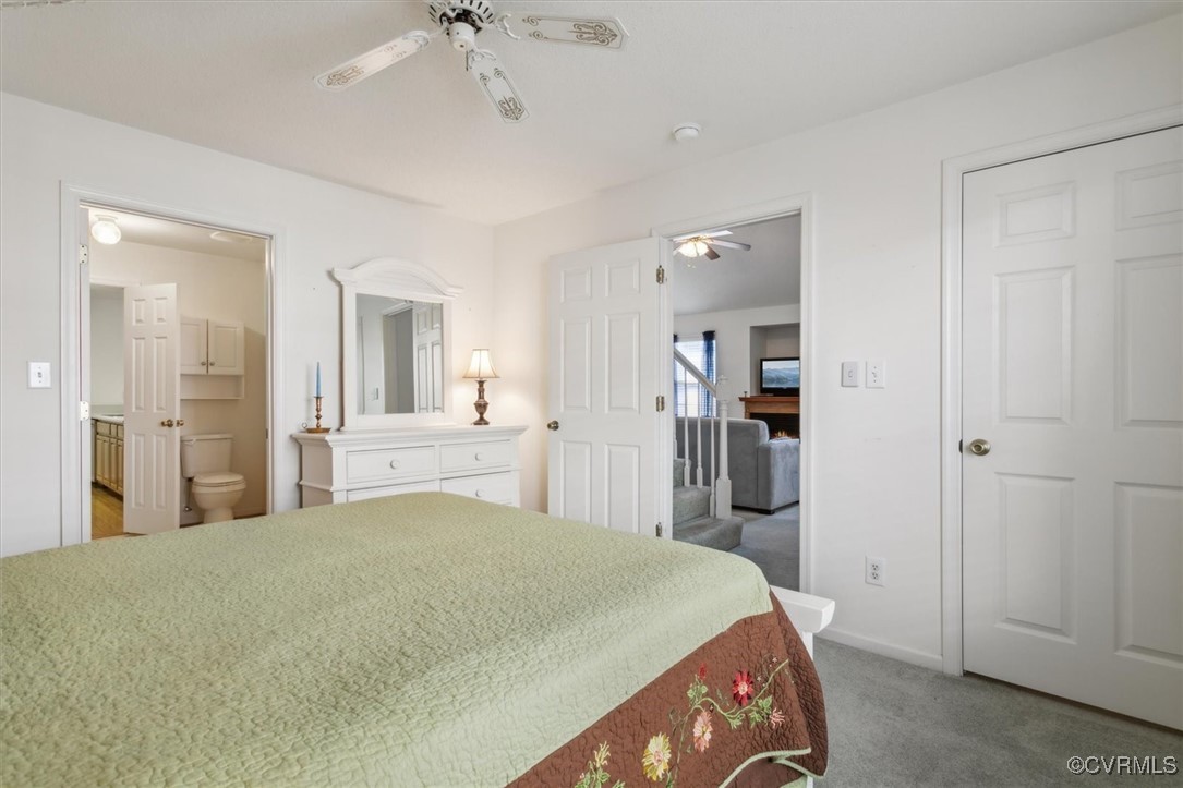 2104 Westgate Circle Williamsburg, VA 23185 - Photo 25 of 45 a bedroom with a large bed and a chandelier