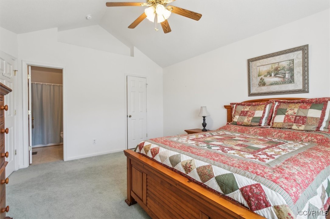 2104 Westgate Circle Williamsburg, VA 23185 - Photo 30 of 45 a bedroom with a bed and a chandelier