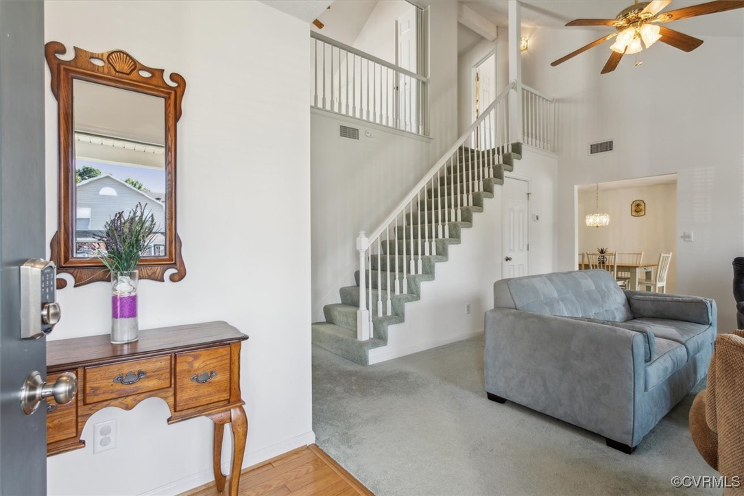 2104 Westgate Circle Williamsburg, VA 23185 - Photo 3 of 45 a living room with couches a flat tv screen and a dining table with a mirror