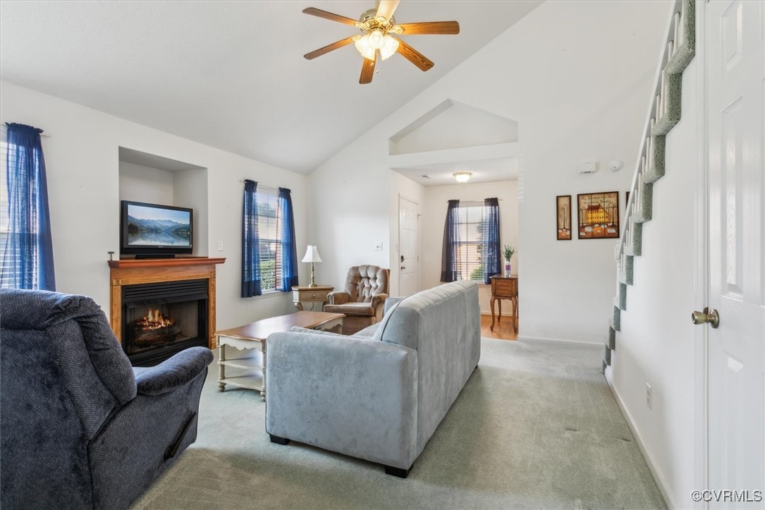 2104 Westgate Circle Williamsburg, VA 23185 - Photo 5 of 45 a living room with furniture a fireplace and a chandelier