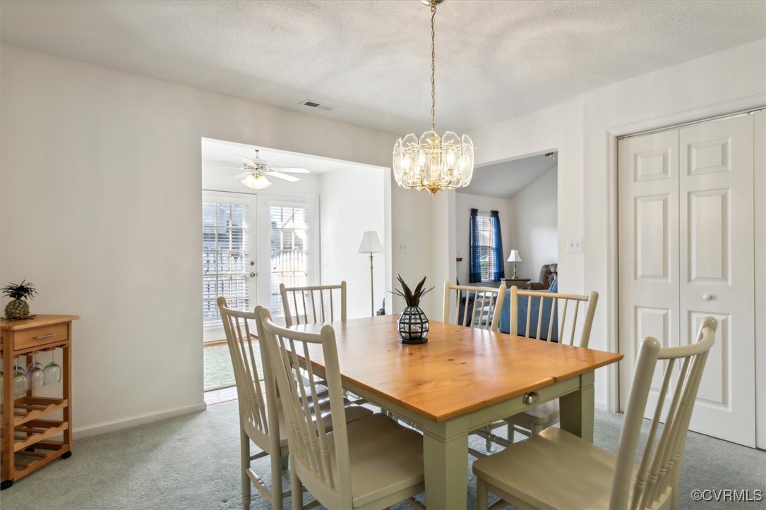 2104 Westgate Circle Williamsburg, VA 23185 - Photo 10 of 45 a view of a dining room with furniture a chandelier and wooden floor