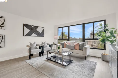 a living room with furniture large window and flat screen tv