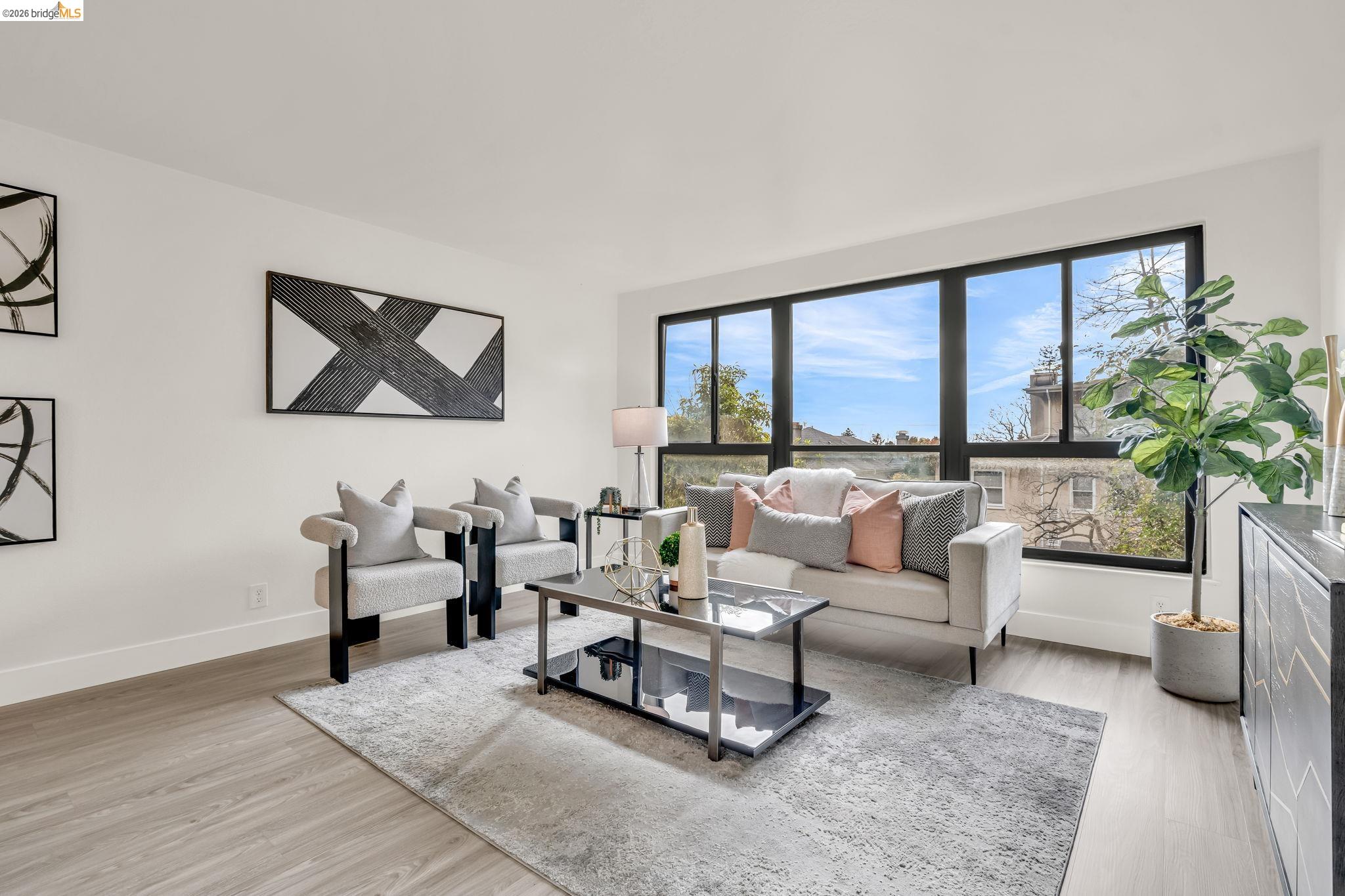 2632 Warring Street, Unit 3 Berkeley, CA 94704 - Photo 10 of 23 a living room with furniture large window and flat screen tv