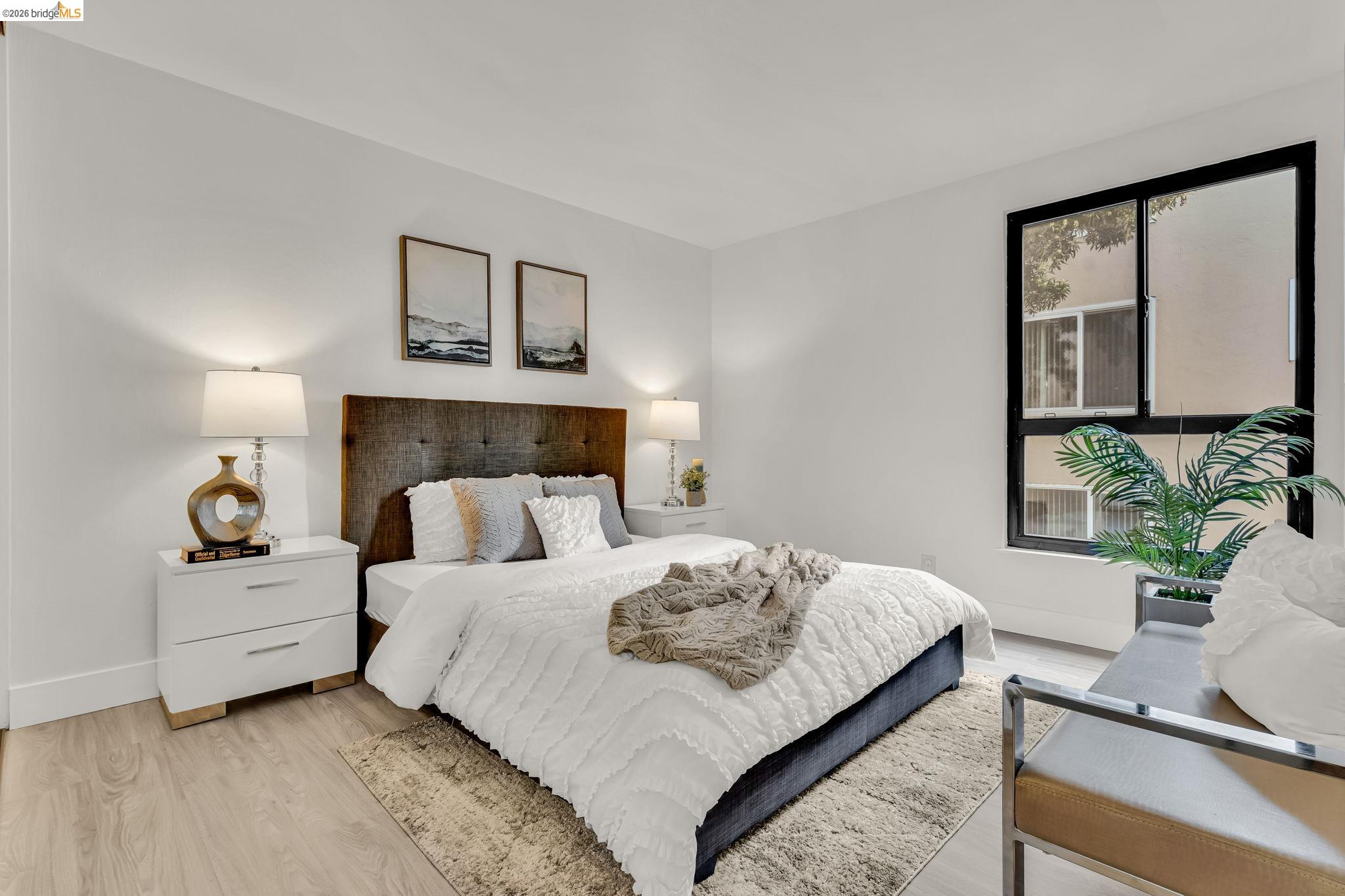 2632 Warring Street, Unit 3 Berkeley, CA 94704 - Photo 11 of 23 a bedroom with a bed lamp and window