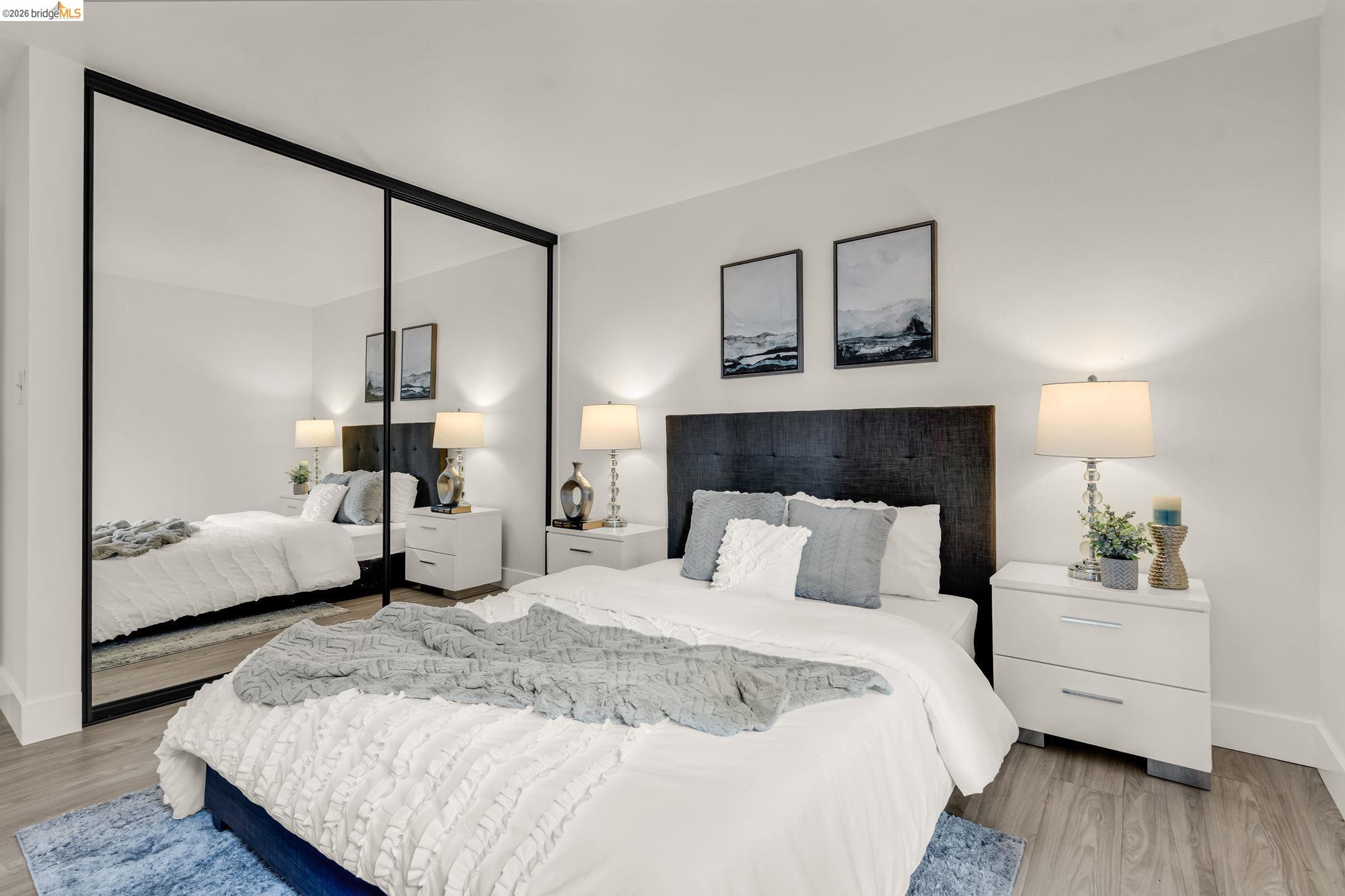 2632 Warring Street, Unit 3 Berkeley, CA 94704 - Photo 12 of 23 a bedroom with a large bed and a painting on the wall