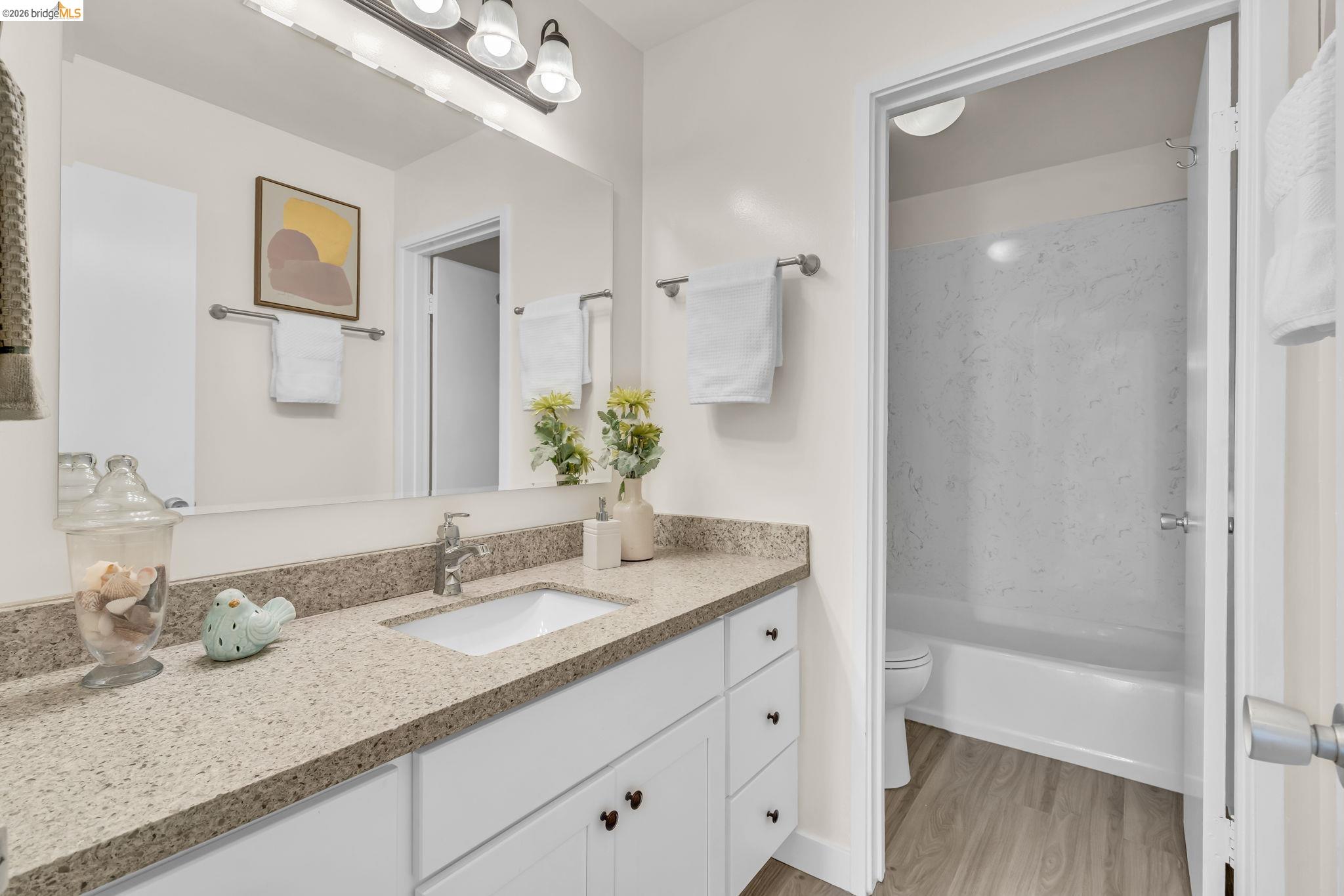 2632 Warring Street, Unit 3 Berkeley, CA 94704 - Photo 13 of 23 a bathroom with a granite countertop sink mirror and double