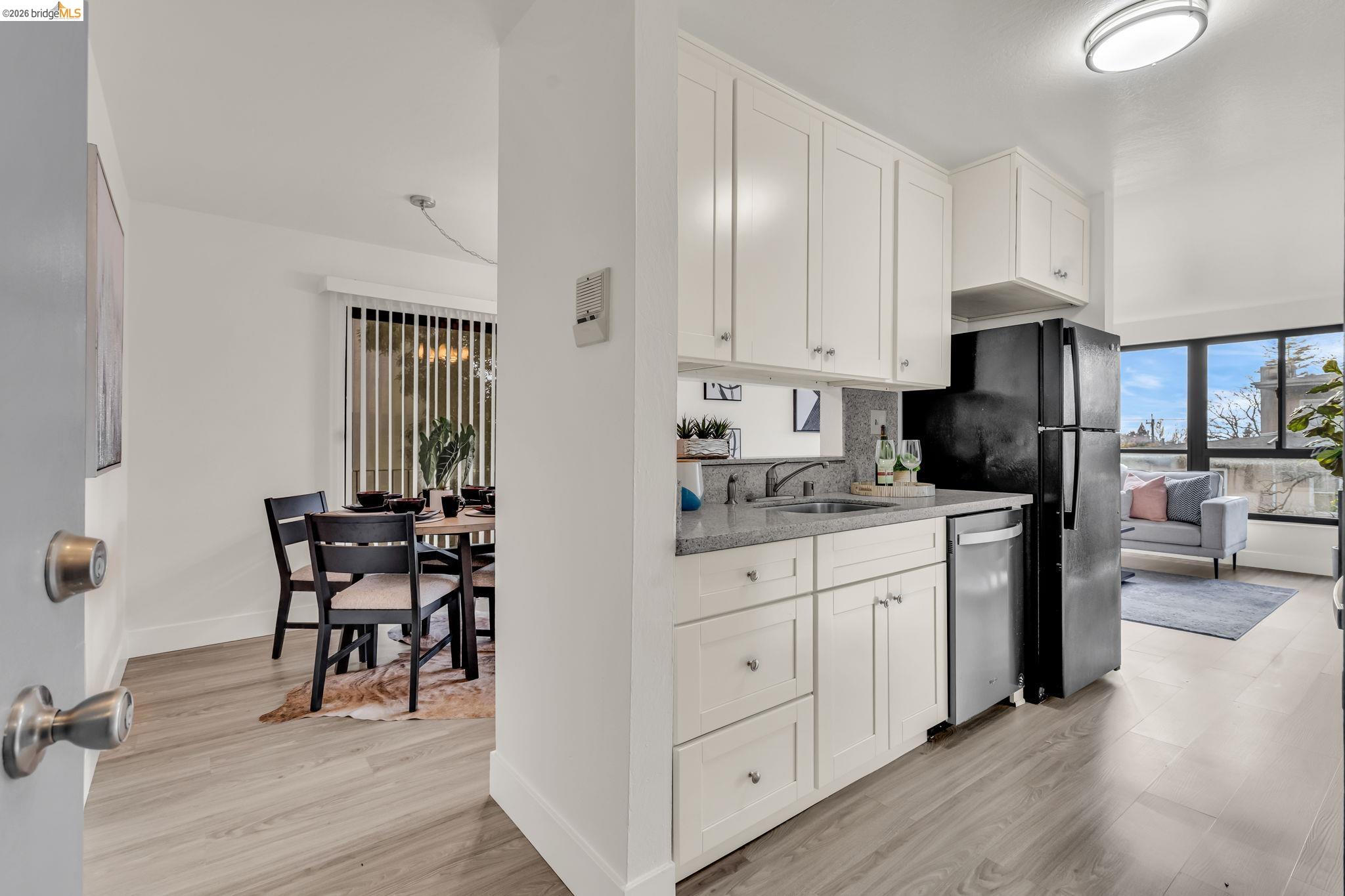 2632 Warring Street, Unit 3 Berkeley, CA 94704 - Photo 4 of 23 a kitchen with granite countertop white cabinets and stainless steel appliances