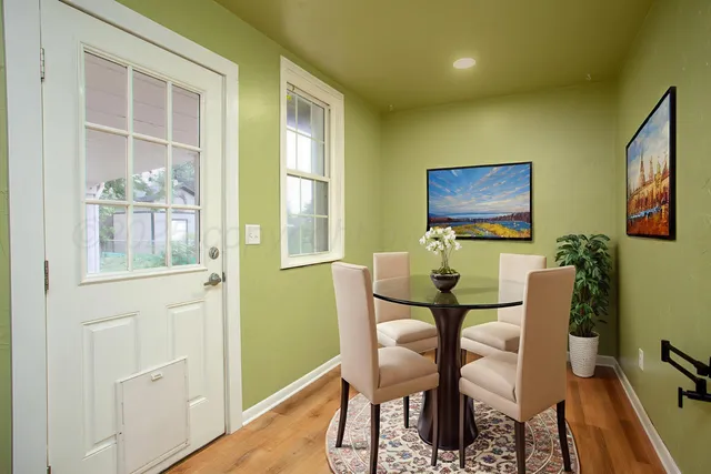 a dining room with furniture and window