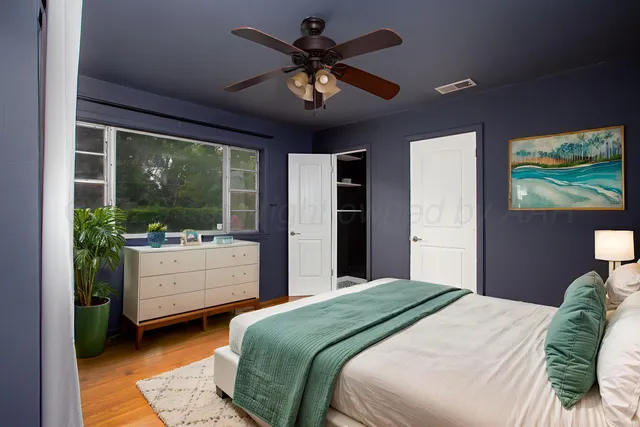 a bedroom with a large bed and a large window