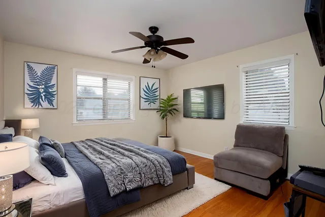 a bedroom with a bed couch and window