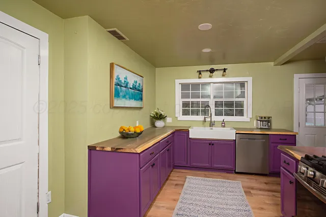 a kitchen with stainless steel appliances granite countertop a sink and wooden cabinets