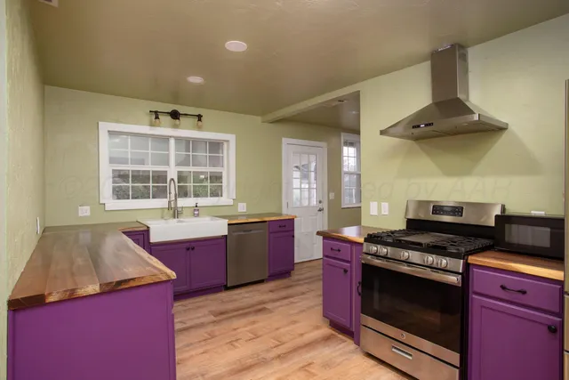 a kitchen with stainless steel appliances granite countertop a stove and a sink