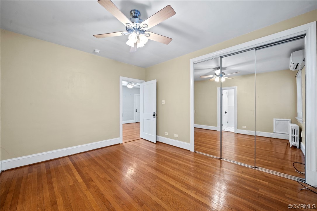 515 North Arthur Ashe Boulevard, Unit U9 Richmond, VA 23220 - Photo 11 of 18 wooden floor in an empty room with a window