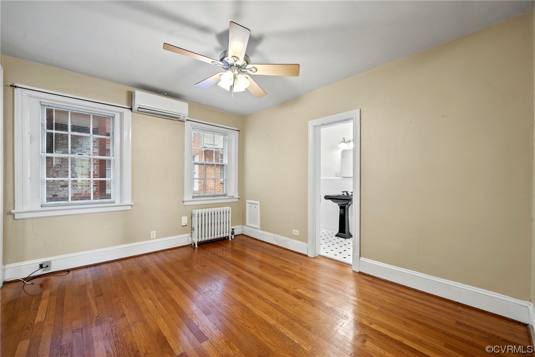 515 North Arthur Ashe Boulevard, Unit U9 Richmond, VA 23220 - Photo 12 of 18 a view of an empty room with wooden floor and a window