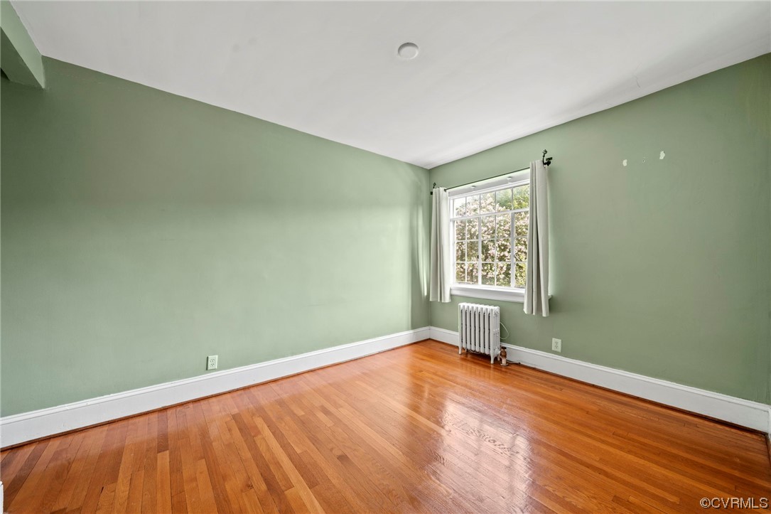 515 North Arthur Ashe Boulevard, Unit U9 Richmond, VA 23220 - Photo 15 of 18 a view of an empty room with wooden floor and a window