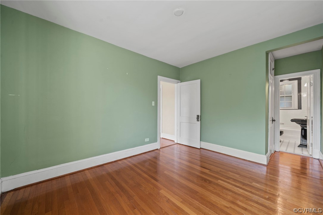 515 North Arthur Ashe Boulevard, Unit U9 Richmond, VA 23220 - Photo 16 of 18 an empty room with wooden floor and windows