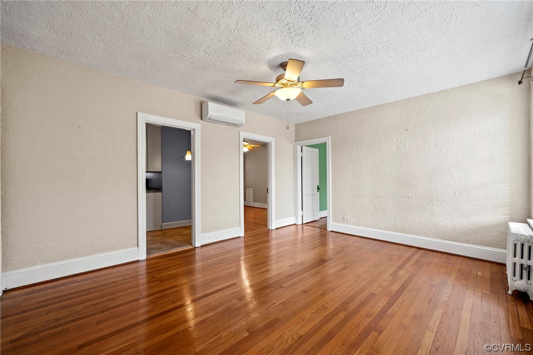 515 North Arthur Ashe Boulevard, Unit U9 Richmond, VA 23220 - Photo 3 of 18 a view of an empty room with wooden floor and a ceiling fan