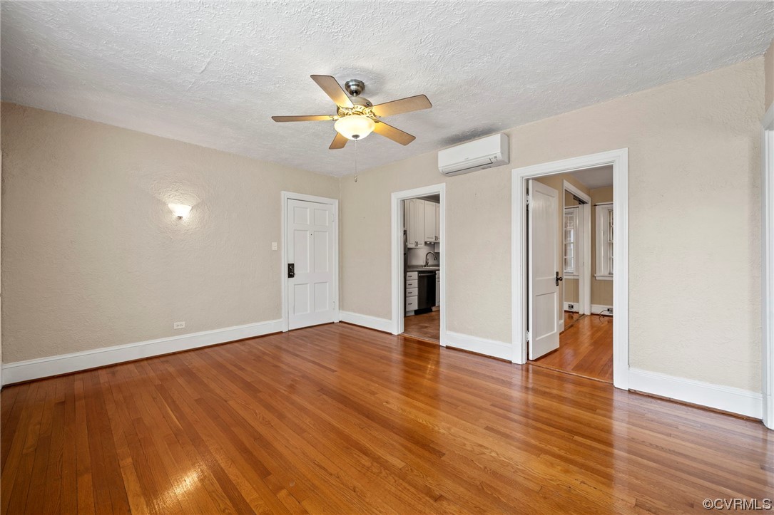 515 North Arthur Ashe Boulevard, Unit U9 Richmond, VA 23220 - Photo 4 of 18 wooden floor in an empty room with a window