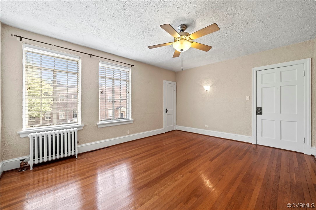 515 North Arthur Ashe Boulevard, Unit U9 Richmond, VA 23220 - Photo 5 of 18 a view of an empty room with wooden floor and a window