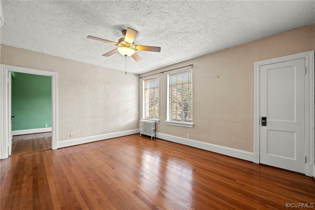 515 North Arthur Ashe Boulevard, Unit U9 Richmond, VA 23220 - Photo 6 of 18 an empty room with wooden floor fan and windows