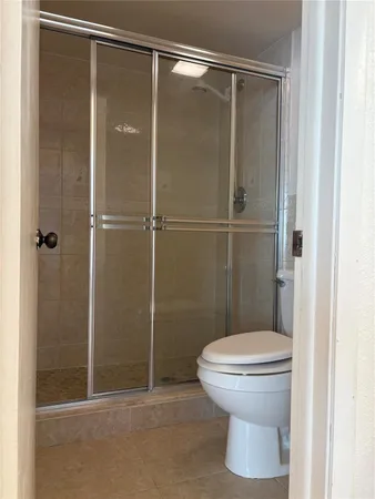 a bathroom that has a toilet and a shower