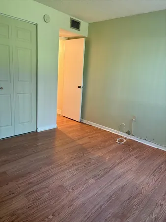 an empty room with wooden floor