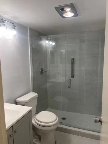 a bathroom with a shower a toilet and a sink