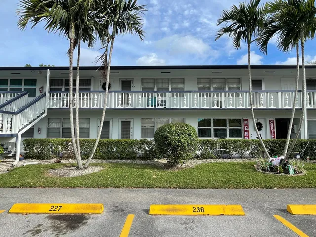 a front view of house with yard and swimming pool