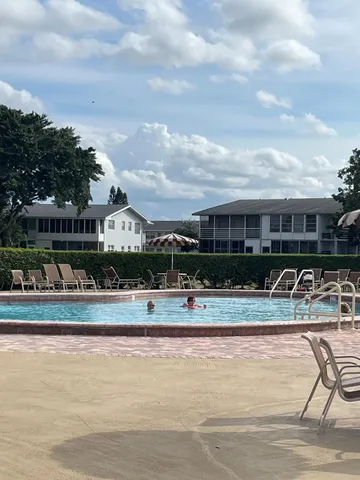 a view of swimming pool with outdoor seating