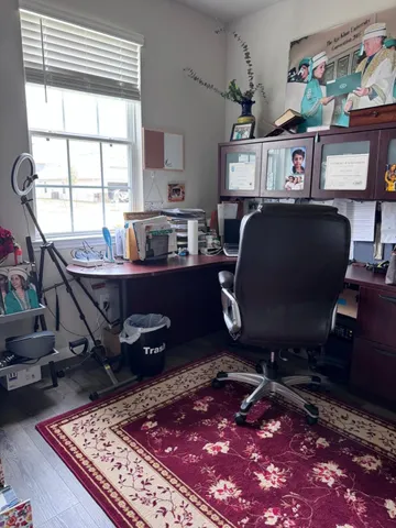 a workspace with furniture and a rug
