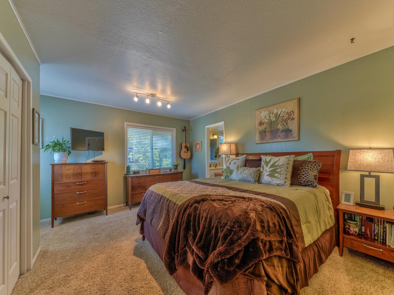 14 Vista Drive Prunedale, CA 93907 - Photo 12 of 31 a bedroom with a bed and a chandelier