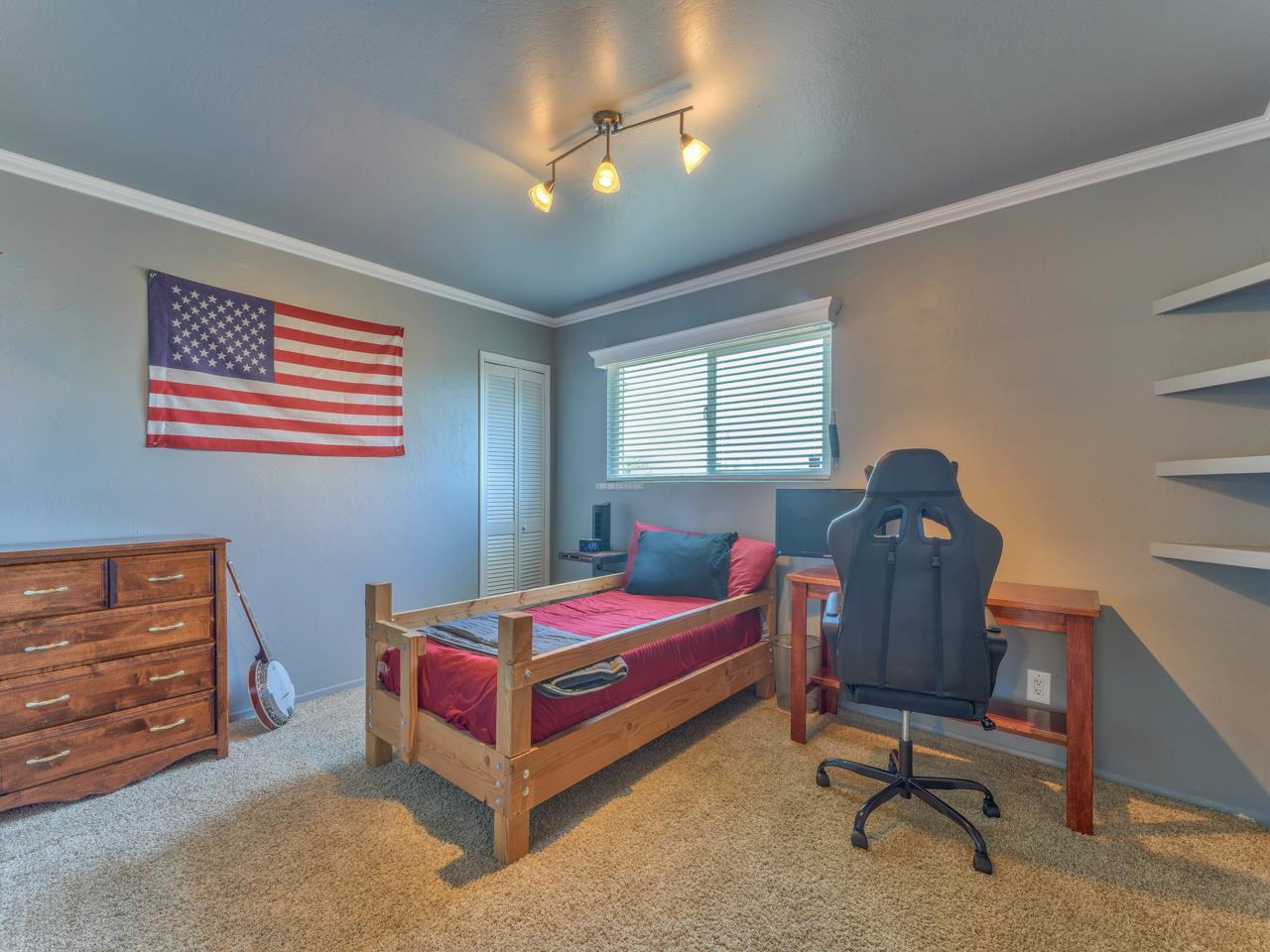 14 Vista Drive Prunedale, CA 93907 - Photo 15 of 31 a bedroom with a bed and a chandelier