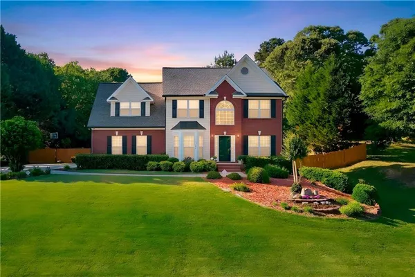a front view of a house with a yard
