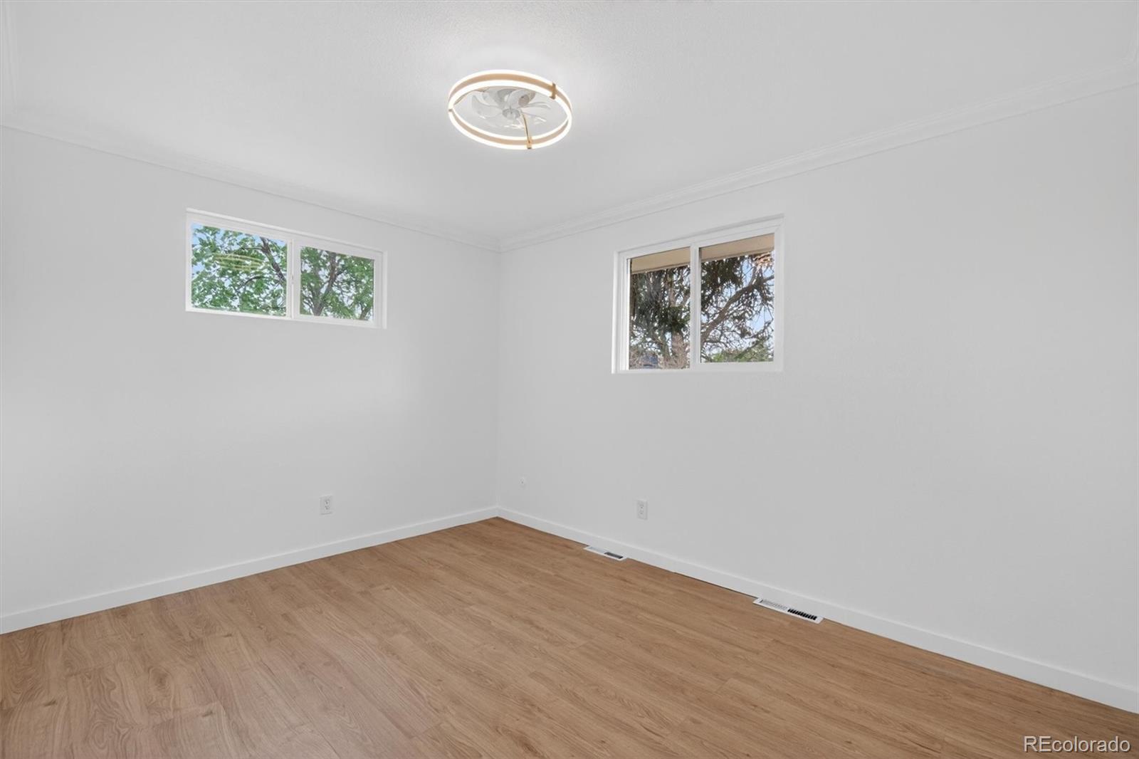 7620 Acoma Court Denver, CO 80221 - Photo 20 of 39 an empty room with wooden floor and window