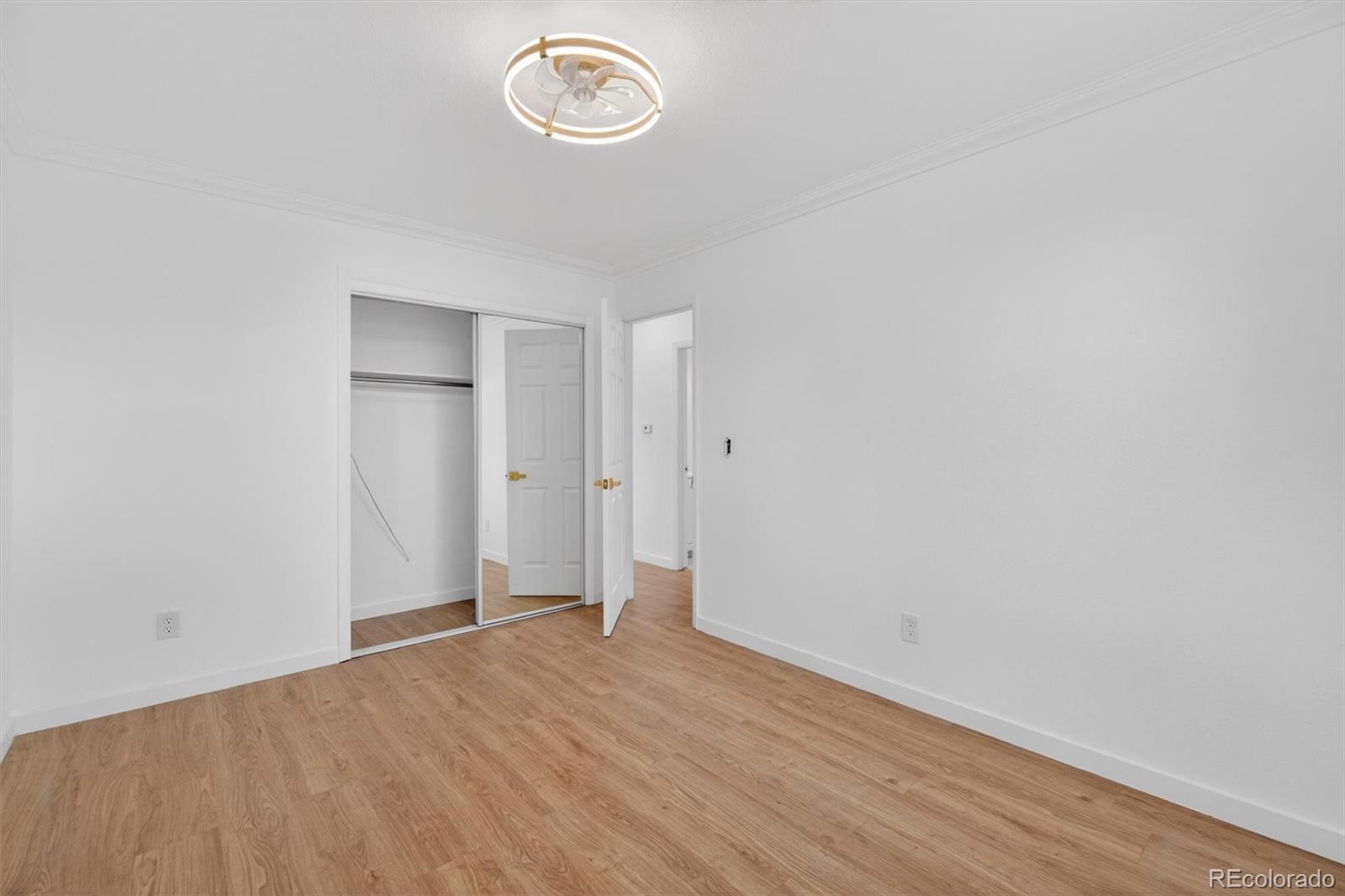 7620 Acoma Court Denver, CO 80221 - Photo 21 of 39 a view of room with wooden floor