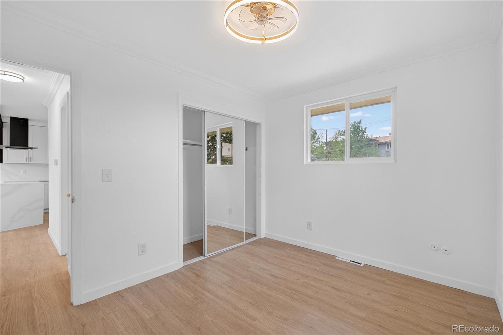 7620 Acoma Court Denver, CO 80221 - Photo 22 of 39 an empty room with wooden floor and window