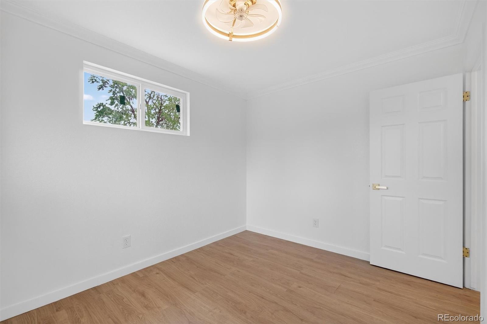7620 Acoma Court Denver, CO 80221 - Photo 23 of 39 an empty room with wooden floor and window