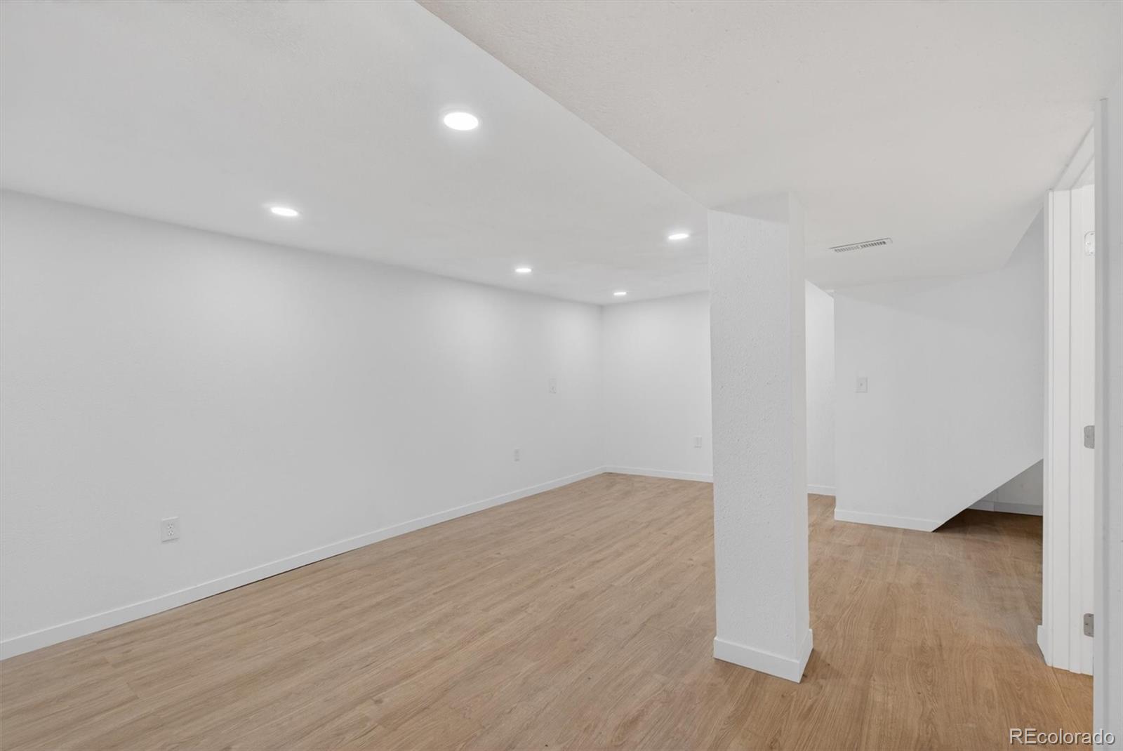 7620 Acoma Court Denver, CO 80221 - Photo 28 of 39 a view of empty room with wooden floor