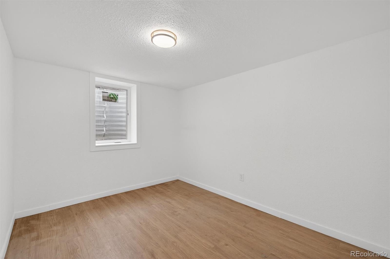 7620 Acoma Court Denver, CO 80221 - Photo 30 of 39 an empty room with a window