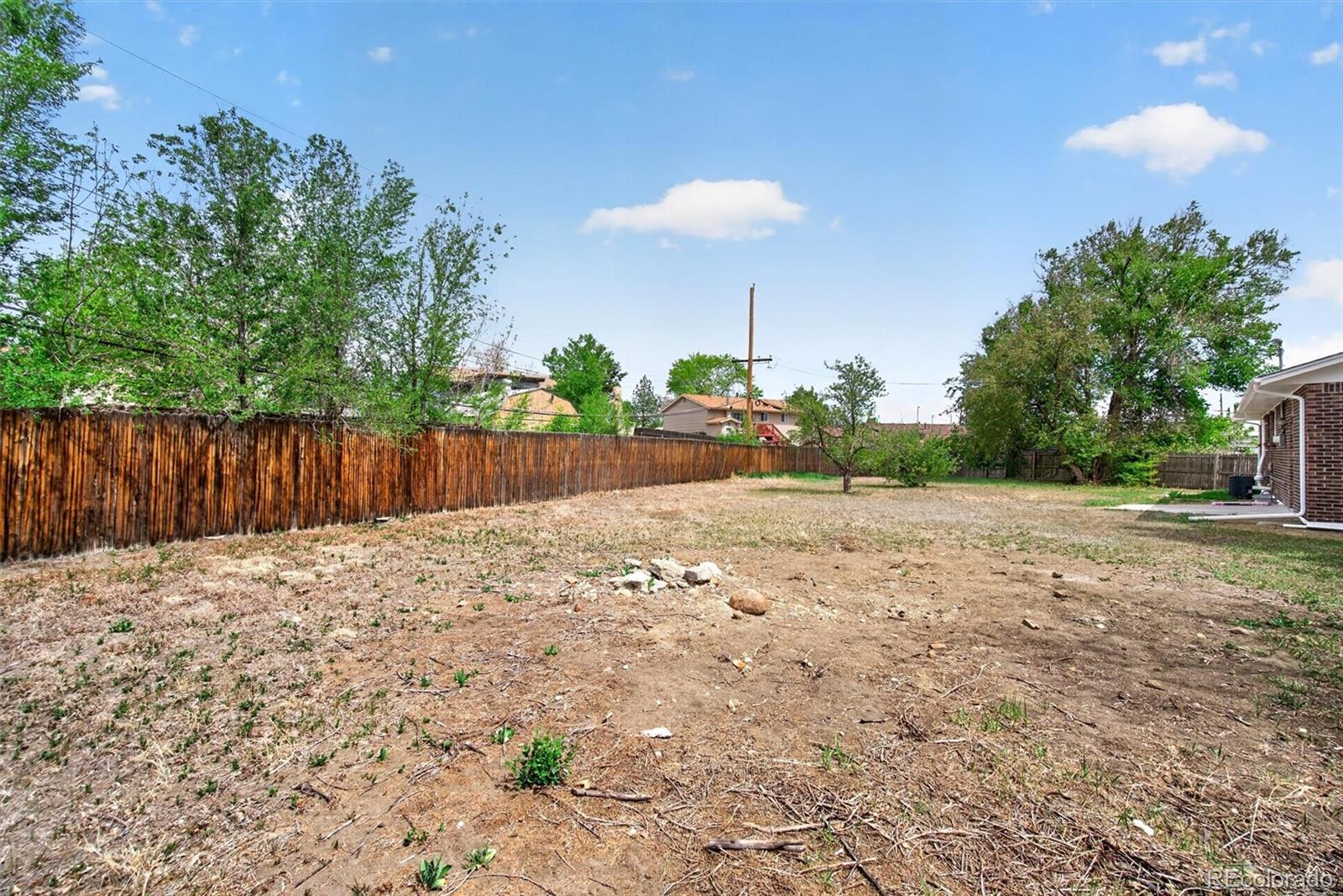 7620 Acoma Court Denver, CO 80221 - Photo 35 of 39 a backyard of a house with lots of green space