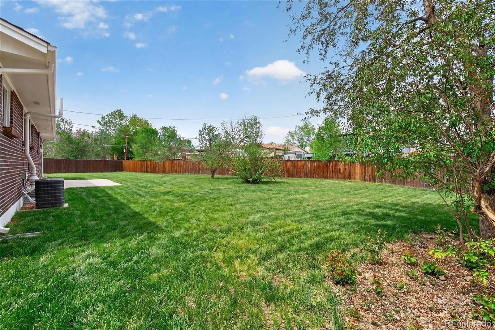 7620 Acoma Court Denver, CO 80221 - Photo 37 of 39 a view of yard with swimming pool and green space
