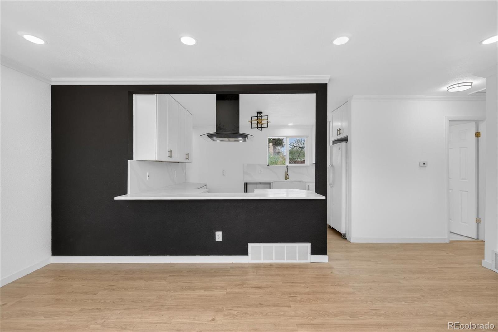 7620 Acoma Court Denver, CO 80221 - Photo 7 of 39 a view of kitchen with wooden floor and window