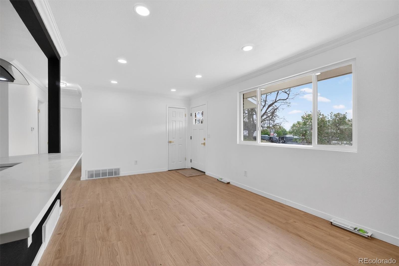 7620 Acoma Court Denver, CO 80221 - Photo 9 of 39 an empty room with wooden floor and windows
