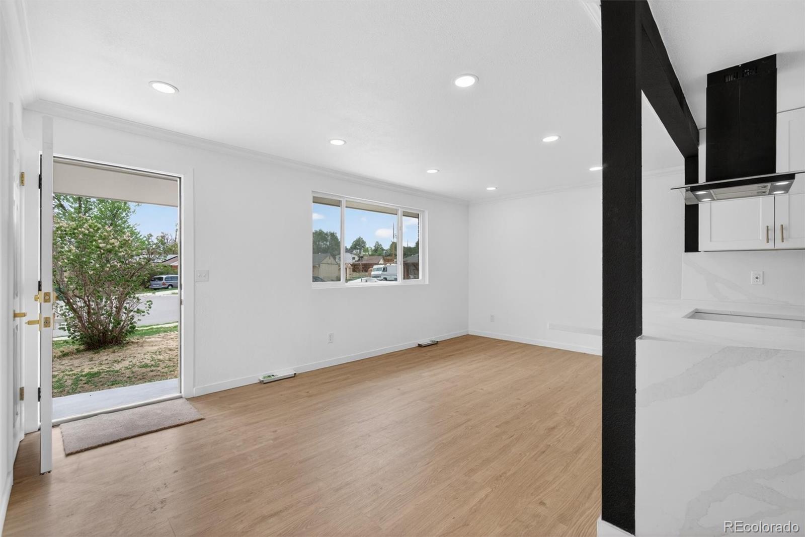 7620 Acoma Court Denver, CO 80221 - Photo 10 of 39 a view of hallway with window and wooden floor