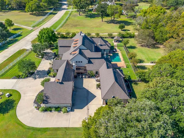 an aerial view of residential houses with outdoor space and swimming pool