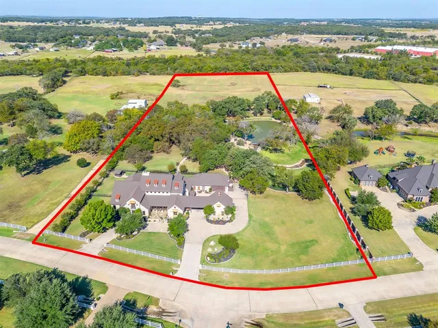a living room with furniture a flat screen tv and a floor to ceiling window