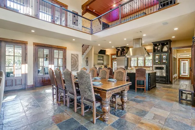 a large kitchen with a table and chairs in it