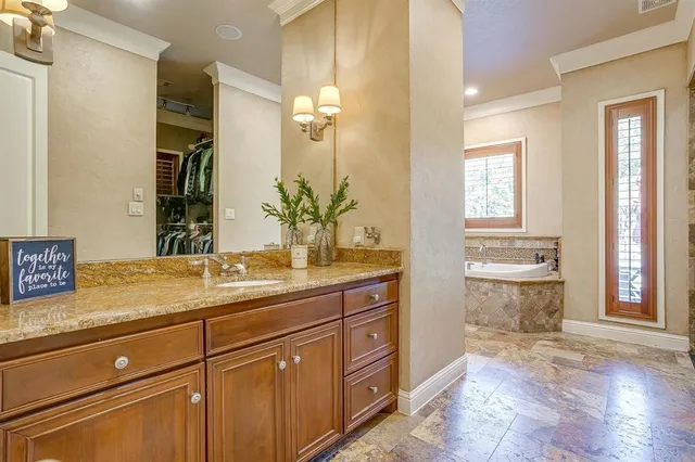 a bath tub sitting next to a bathroom sink