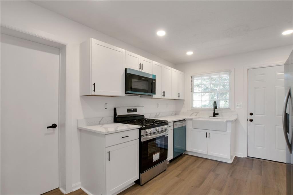 2326 Mark Trail Decatur, GA 30032 - Photo 1 of 19 a kitchen with a stove a sink and a microwave