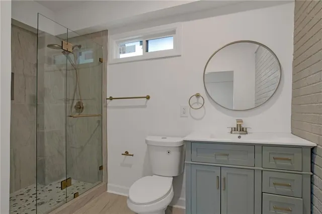 a bathroom with a sink toilet and shower